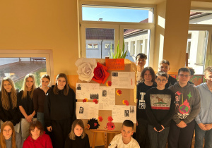 Uczniowie na tle wystawy dotyczącej Bohaterek Powstania Warszawskiego