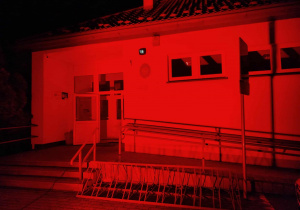 Budynek szkoły Podstawowej w Kalinie rozświetlony na czerwono.