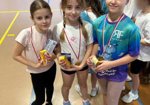 Uczennice klasy 2 prezentują medale i upominki