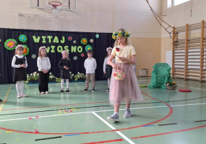 Pani wiosna sypie kwiatami poczas przedstawienia