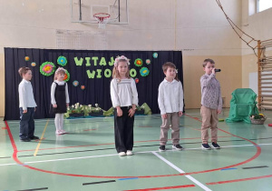 Uczniowie podczas występu artystycznego na sali gimnastycznej