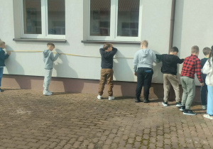 Uczniowie dokonują pomiarów szkoły